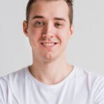 smiling-man-white-t-shirt-gray-b